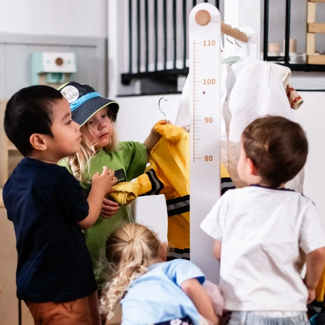 Children enjoying dress-up play together in the learning studio