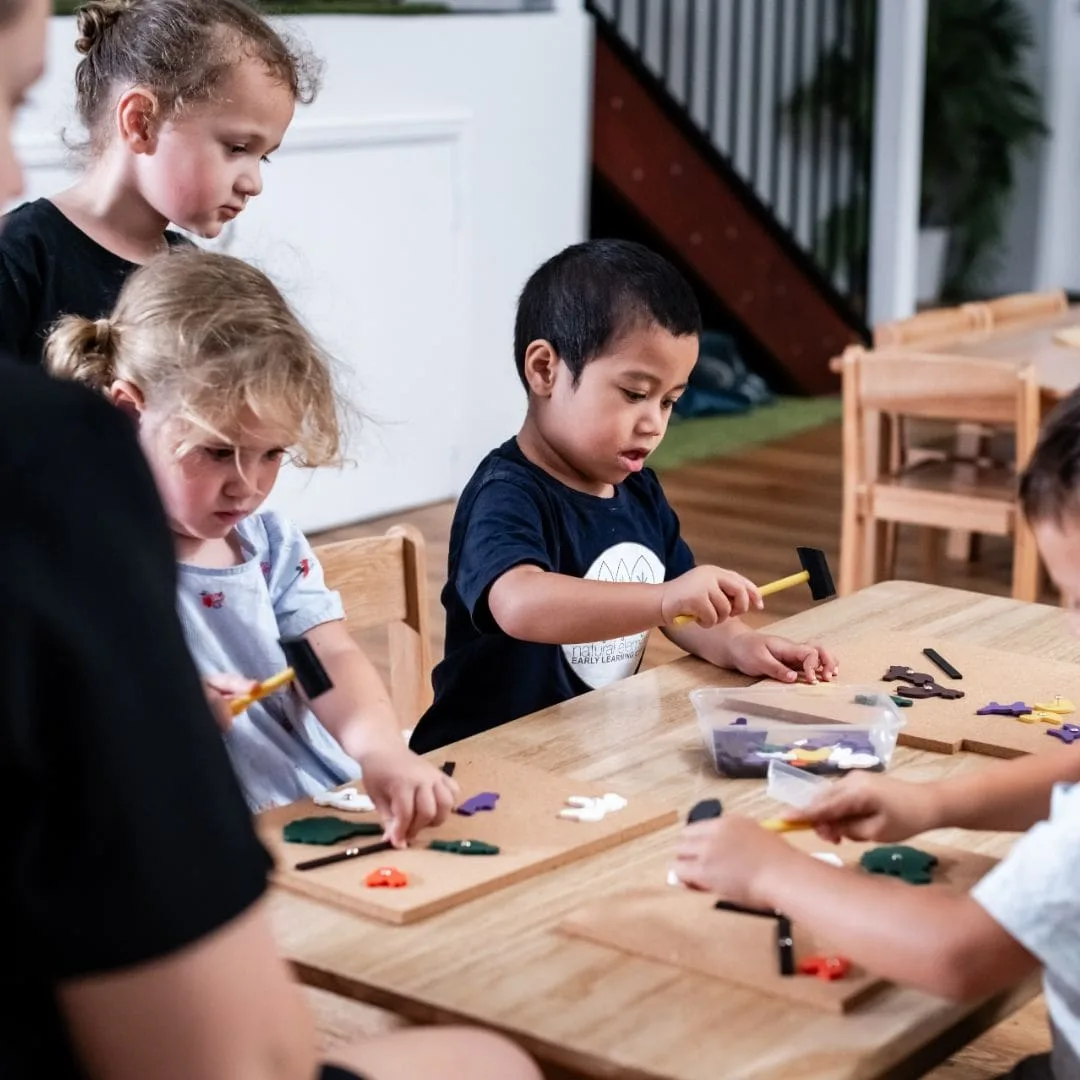 Children creating together at the group craft table
