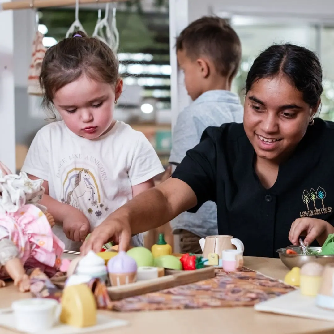 Children working together at a table in the kindergarten studio